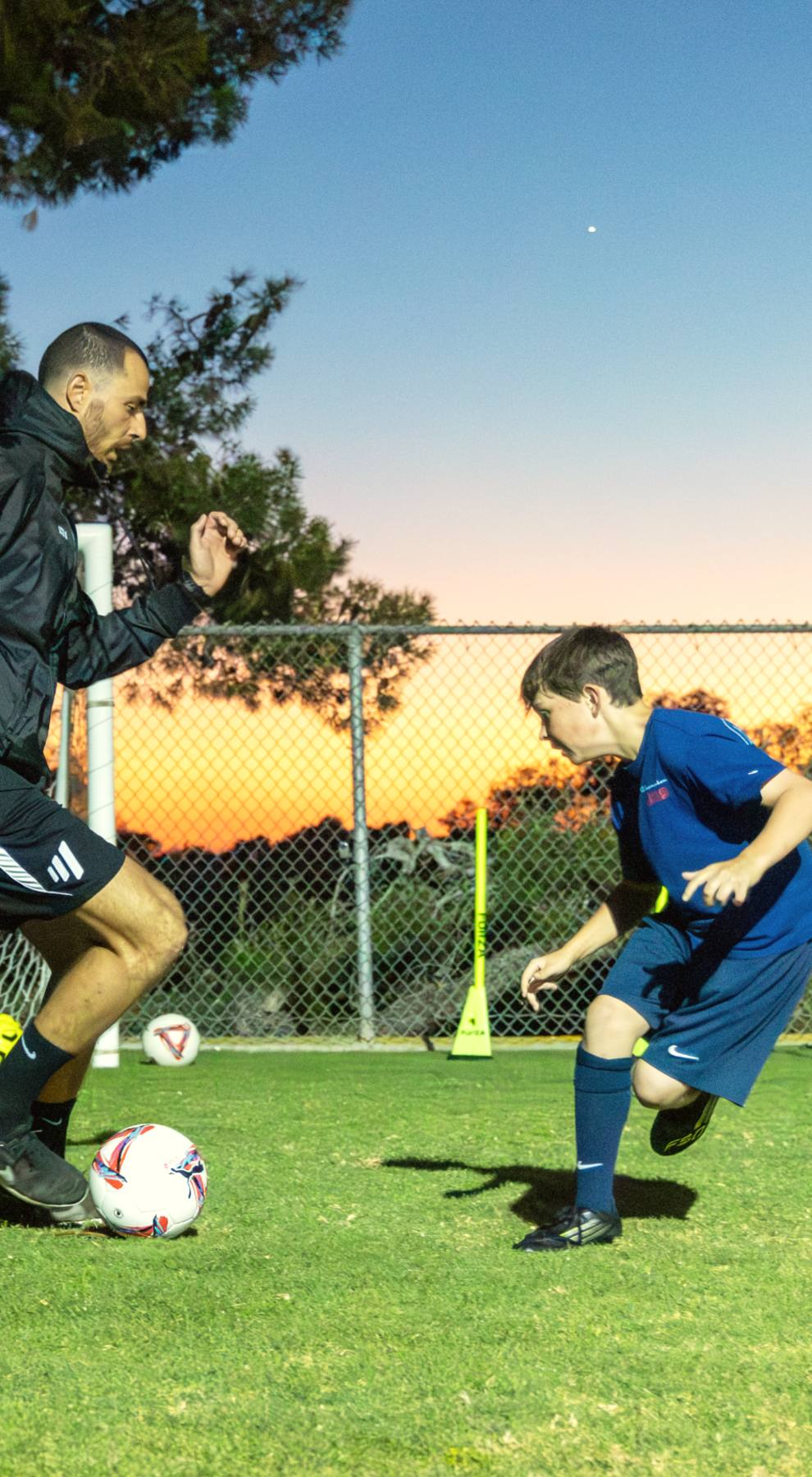 A player and Coach Luka face off 1v1 at sunset, tryout preparation at The Soccer Lab, Carlsbad